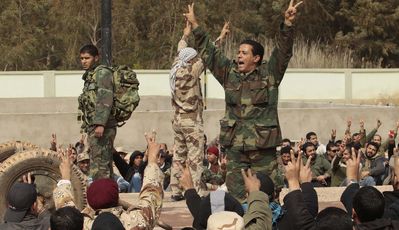 Milicians civils que s'han unit a les forces rebels criden consignes contra Gaddafi a Bengasi / REUTERS