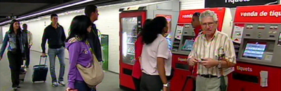 Passatgers de Rodalies davant de màquines validadores de bitllets.