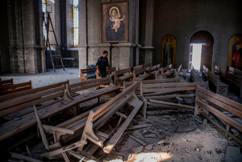 Un hombre revisa los escombros en el interior de la catedral de Shusha.